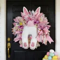 Detail of plush bunny Easter wreath with colorful ribbons and eggs on a front door - 2026 New Bunny Wreath C