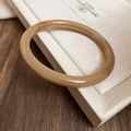Close-up of vintage amber acrylic resin bangle with marble texture and polished finish - 60# Bracelet-Amber Caramel Round