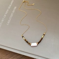 Detail of tiger eye stone and baroque pearl pendant on a gold chain necklace - Square Irregular Pearl Style (11#) / Gold
