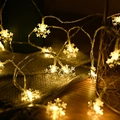 Warm white snowflake LED string lights on grey fabric for camping and festive decor - Small Snowflake / 3m 20-LED Battery Powered / Warm Tone