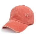 Close-up detail of coral orange washed denim baseball cap showing distressed texture - Orange