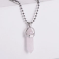 Close-up of pink crystal hexagonal pillar pendant with a silver bead chain necklace - Opalite