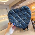Detail of a heart-shaped crossbody bag with diamond quilting and glossy finish - Black