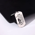 Macro shot of silver stainless steel dog tag keychain with father-son silhouette engraving - Style 19 (Father & Son Silhouette)