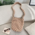 Detail of beige fleece bucket bag with red heart patterns on a soft sofa - Beige Red (Heart)