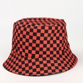 Detail view of the red and black checkered pattern on a reversible cotton bucket hat - M / Orange