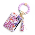 Detail of floral zipper card holder with purple silicone bead wristlet and tassel charm - Light Purple