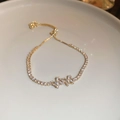 Elegant gold-plated bracelet with pavé zircon butterfly accents and adjustable pull slider - Gold