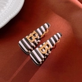 Macro view of leaf earrings with black and white stripes and a golden letter B accent - No.2 925 Silver Needle Alloy Geometric B