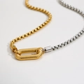 Detail of two-tone gold and silver box chain necklace with a textured oval link connector - Box Chain Spiral Clasp / Two-tone Gold