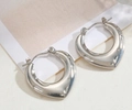 Detailed close-up of chunky silver hoop earrings with irregular hammered texture surface - Silver Style K7-101