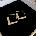 Detail shot of silver geometric L-shaped hoop earrings on black velvet in a jewelry box - Geometric L-Shaped Hook Earrings (20#)