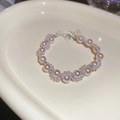 Detailed view of pink pearl bracelet with rhinestones on cream ceramic tray - Silver