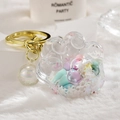 Translucent cat claw keychain with pastel beads and gold hardware on plush surface - Bead Paw Style / White