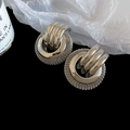 Close-up of silver metal twisted mesh ring earrings with triple stripe buckle details - Silver