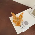 Butterfly hair claw clip with orange marble texture and gold metal spring mechanism - Orange