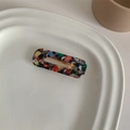 Detailed shot of rectangle tortoiseshell hair clip with colorful mosaic pattern on ceramic tray - Black Multi-color Marble Square