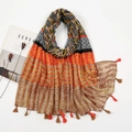 Detail of bohemian scarf with geometric patterns and fringe edges on a white background - XB1005-01 Orange-Brown Geometric Tassels