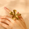 Exaggerated large gold flower ring featuring a polished five-petal design on index finger - Gold (A-704)