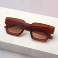 Detailed view of square thick frame sunglasses in amber on a geometric display stand - Dark Tea Frame Tea Lens