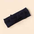 Detailed close-up of dark blue knit bow headband for infants on beige background - Dark Blue