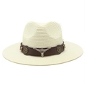 Detail of a straw cowboy hat with a brown leather band and silver bull head ornament - Cream