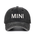 Close-up of white 3D MINI embroidery on washed dark grey cotton baseball cap fabric - Adjustable / Black MINI