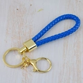 Handmade blue woven leather keychain with gold metal buckle and ring on wooden background - Generation 1 Round Dragon Woven Buckle (Light Gold) / Sapphire Blue