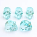 Transparent blue resin skull figurines with unique gold crackle patterns on white background - No.17 (Transparent Blue Gold Crackle)