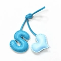 Close-up of leather bag charm featuring a blue letter S and heart with neat stitching - Sky Blue with Light Blue Heart