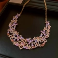 Detailed macro view of a gold flower necklace set with purple and pink marquise stones - Necklace (Gold-Purple)