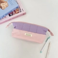 Detailed close-up of a quilted two-tone pencil case in lavender and soft pink hues - Purple and Pink