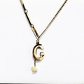 Golden titanium steel necklace with G-letter pendant and fringe cube charm on white base - Gold Initial G (8847)