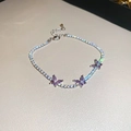 Detailed macro view of silver tennis bracelet with three sparkling purple zircon butterflies - Silver Purple Butterfly