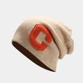Macro detail of oatmeal knitted beanie with orange chenille letter C embroidery - M (56-58cm) / Beige
