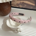 Pink polka dot fabric headband with a handmade label on a white ceramic mug - Pink-Polka Dot