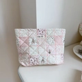 Detail showing quilted cotton floral makeup bag with cute cartoon rabbit and label - Checkered Floral Rabbit