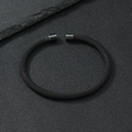 Detail of minimalist black mesh stainless steel cuff bracelet with smooth cylindrical ends - 5mm / Black