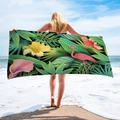 Outdoor view of a large beach towel with flamingo and tropical floral microfiber print - Flamingo Floral