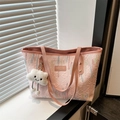 Pink quilted tote bag with colorful embroidery and white cloud pendant on a windowsill - Pink