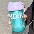 Green portable water cup with lavender lid and NDJU print, handheld outdoor view - 580ml / Purple
