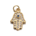 Macro detail of golden Hamsa Hand pendant with blue gemstone and white crystals - Hamsa Hand Pendant