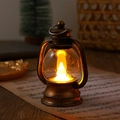 Detail of vintage bronze LED lantern on musical score with festive warm yellow light - Brushed Finish