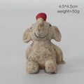 Miniature brown resin elephant figurine looking up with a red apple on its head - Elephant with Red Apple