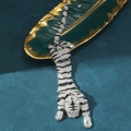 Dettaglio ravvicinato di una spilla tigre con cristalli e smalto nero su foglia in ceramica - Stile D Tigre d'Argento