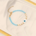 Detail of beaded Hamsa Hand bracelet with blue crystal beads on marble tray - 6# Blue Bracelet