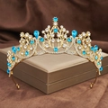 Macro shot of gold baroque crown with blue crystal teardrops on a jewelry box - Gold + Lake Blue Rhinestone
