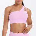 Close-up of light pink one-shoulder sports bra with seamless asymmetric strap design - Sakura Pink