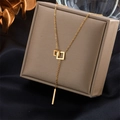 Y-vormige gouden titanium stalen ketting met vierkante hangers op een bruin sieradendoosje - Goud