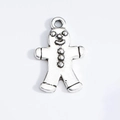 Macro view of antique silver gingerbread man pendant with detailed metal engraving - Retro Silver Gingerbread Man
